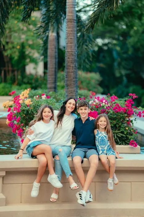 Family of four laughing together during an outdoor session