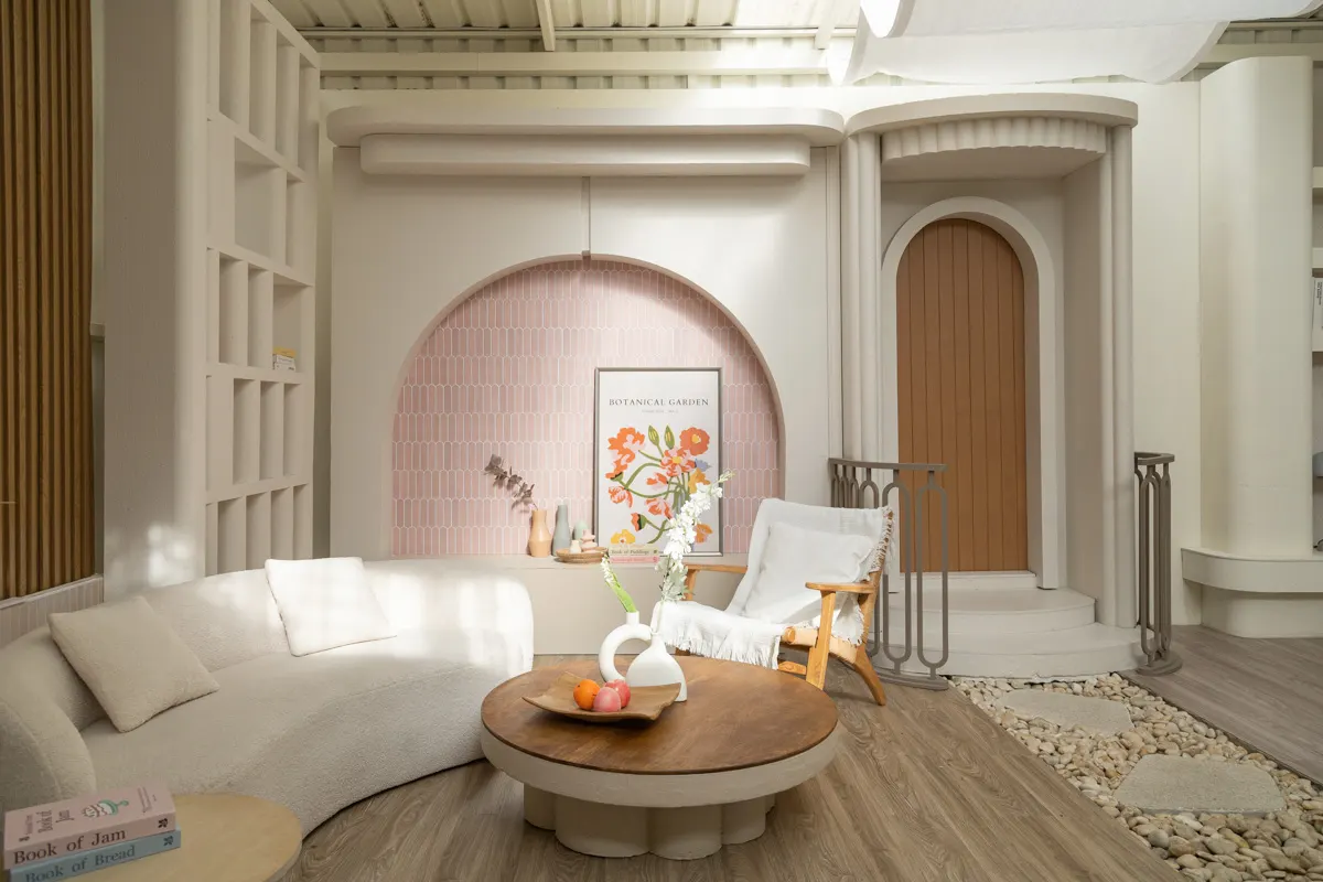 Furnished room lit by large windows