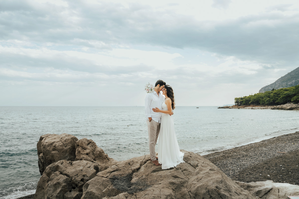 Wedding couple walking on a Thai beach during their wedding day